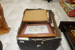 A box containing various prints, mirrors etc.