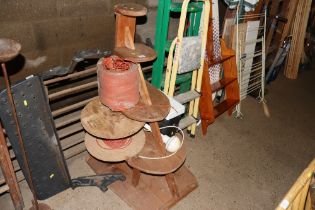 A graduated wooden five tier stand; a reel of rope