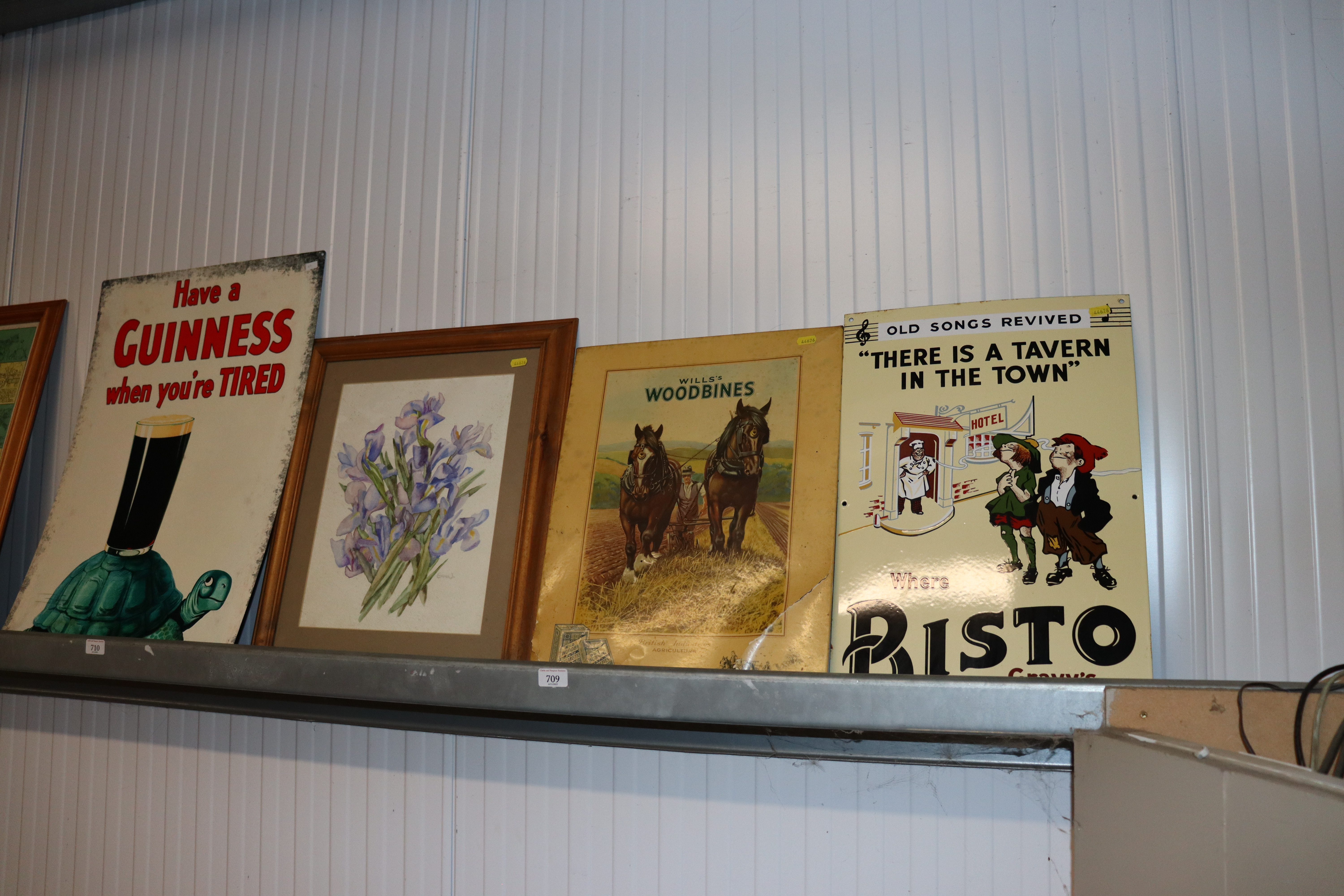 A "Bisto" advertising sign together with a "Wills Woodbines" advertising sign and a still life study