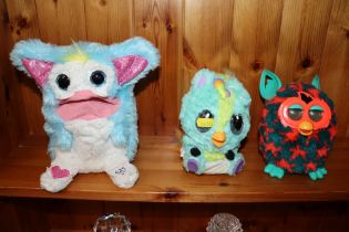 A Furby toy, a Hatchimals toy and Tomy toy