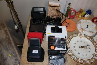 Three TomTom satnavs, dashcams, a Navman etc.