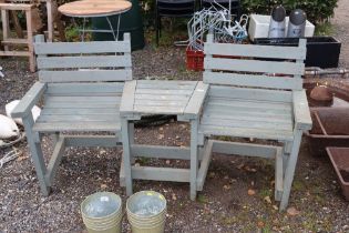 A wooden side by side garden bench