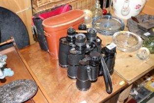 Three pairs of binoculars, two with cases