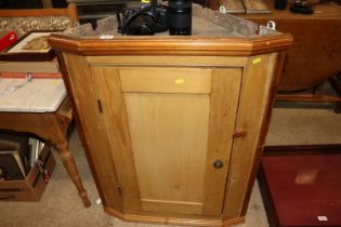 A 19th Century stripped pine corner cupboard