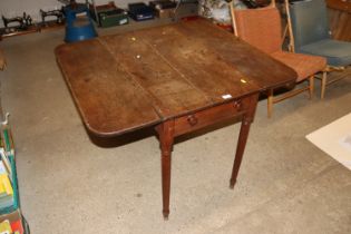 A 19th Century Pembroke table raised on tapering s