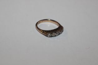 A gold ring, marks rubbed set with five graduated