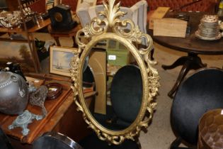 A Hollywood Regency wall mirror by Syroco USA