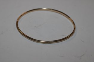 A gold bangle, marks rubbed, approx. total wright