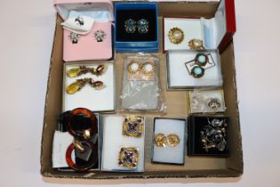 A box containing Chanel and other clip on ear-ring