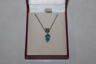 A 925 silver pendant set with blue stone hung to f