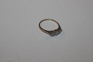 A yellow metal ring, marked rubbed set with three