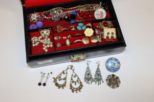 A black jewellery box and contents of costume jewe