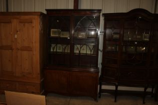 A Georgian walnut and mahogany bookcase raised on