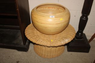 A wicker side table and a cane vase