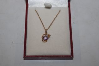 A 9ct gold pendant set amethyst and diamond hung t