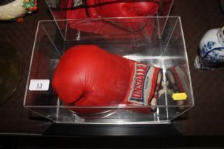 A cased boxing glove signed Frank Bruno