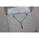 A 14ct white gold necklace with diamond pendant an