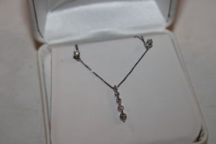 A 14ct white gold necklace with diamond pendant an