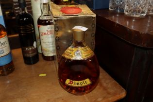 A boxed bottle of Dimple Deluxe Scotch whiskey wit