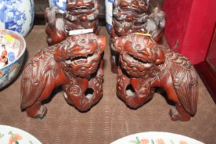 A pair of Chinese carved hardwood Dogs of Fo