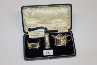 A cased Birmingham silver three piece cruet set
