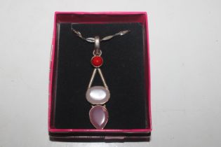 A silver rose quartz pendant on silver chain