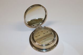 A silver jewellery box, the lid inset with a mirro