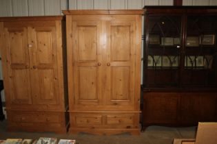 A stripped pine two door wardrobe fitted two drawe