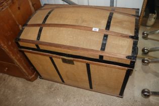 A canvas and batten dome topped travelling trunk