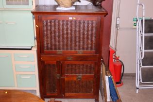 A cane fronted desk with cupboards below AF