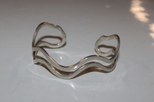 A Sterling silver double wave torque bangle, appro