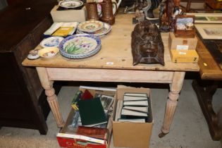 A stripped pine table raised on