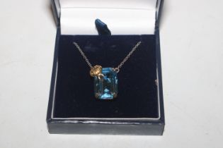 A 925 silver pendant set with blue stone hung to f