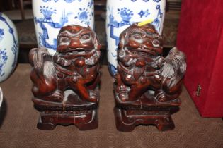 A pair of Chinese carved hardwood Dogs of Fo