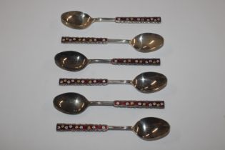 A set of six Oriental white metal and enamel decor