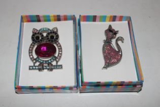 Two boxes brooches in the form of an owl and a cat