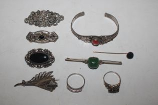 A collection of silver and white metal brooches, b