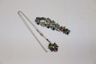 A multi coloured stone pendant hung to a fine link