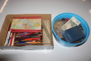 A box containing pens and pencils, various coins,