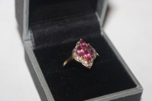 A 9ct gold ring set with coloured stones and chip