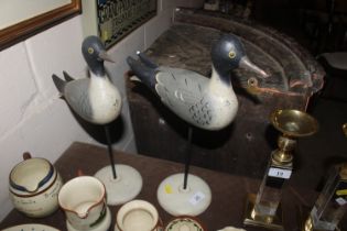 A pair of wooden models of seagulls