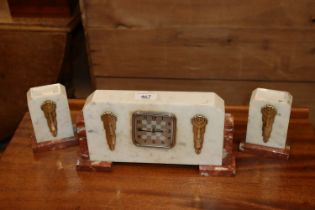 An Art Deco three piece marble clock garniture set