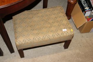 An upholstered footstool