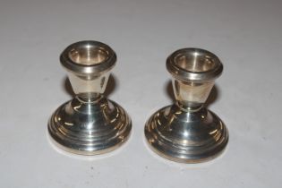 A pair of dwarf silver candlesticks