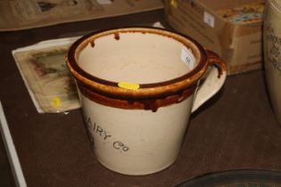 A Maypole Dairy Co. glazed pottery measure