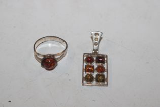 A Sterling silver and amber ring and similar penda