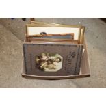 A box containing various pictures and prints and t