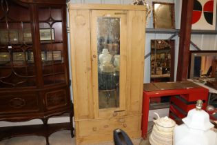 A Victorian pine single door mirror fronted wardro