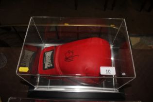 A cased boxing glove with signature