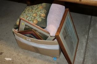 A box containing various pictures and cushions